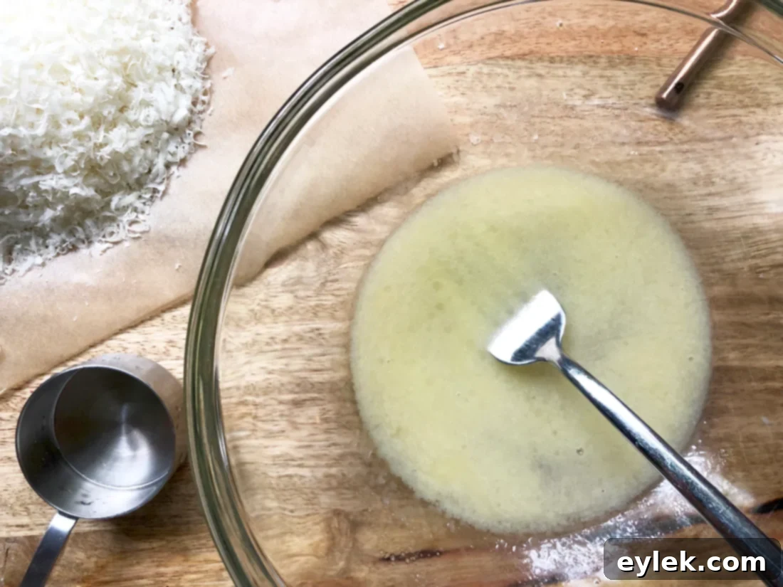 Close up of finely grated Parmigiano-Reggiano cheese for einkorn crackers