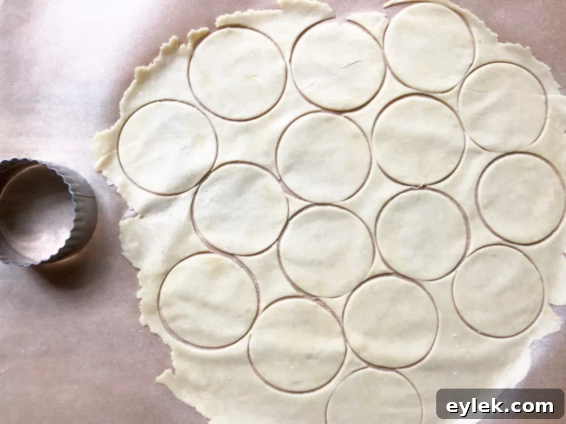 Cutting out einkorn cheese crackers from rolled dough