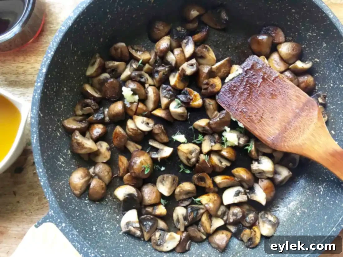 Sautéing mushrooms in butter and olive oil.
