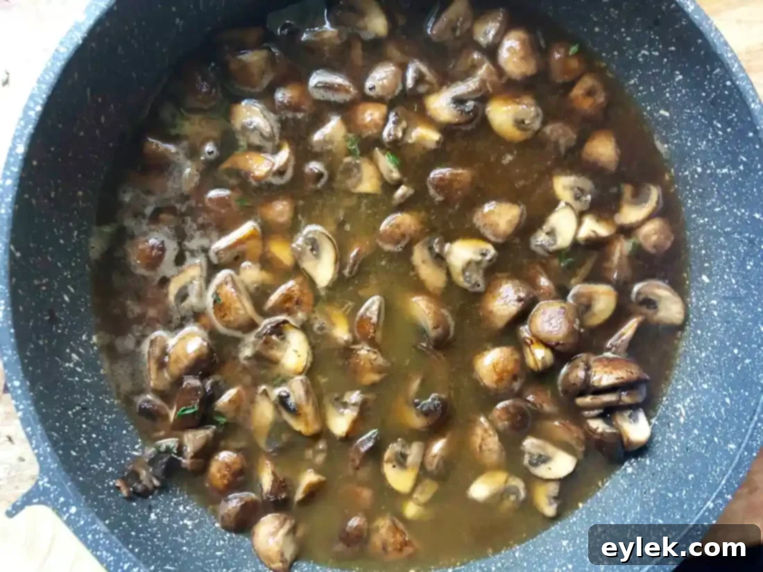 Mushrooms simmering in Marsala wine and vegetable stock.