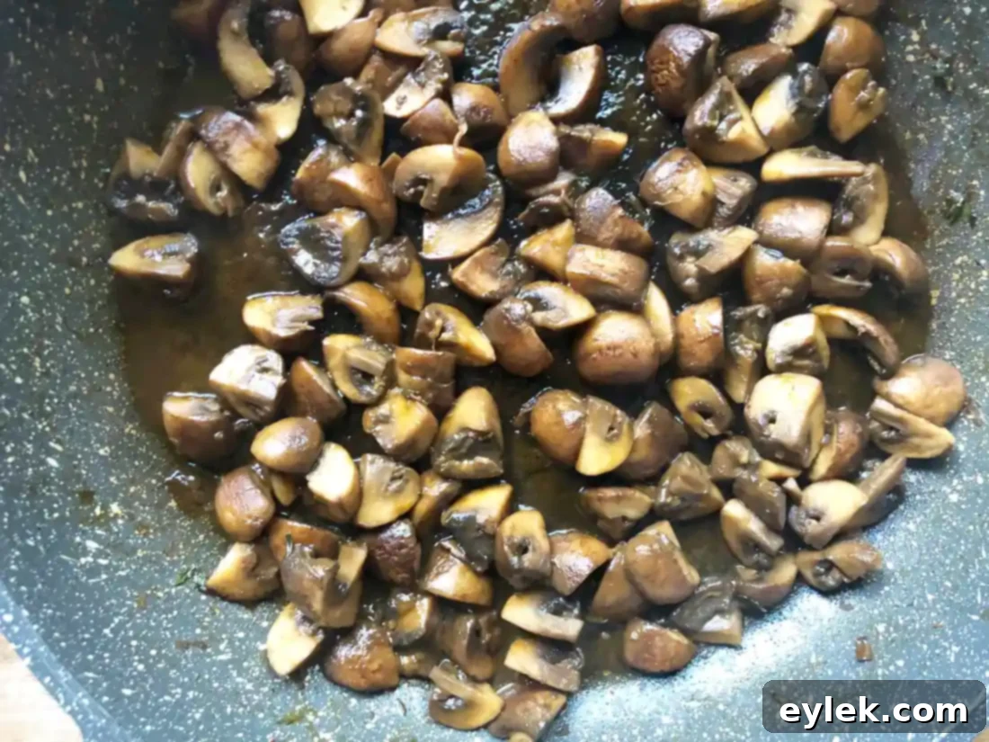 Close-up of cooked Marsala mushrooms in a pan.