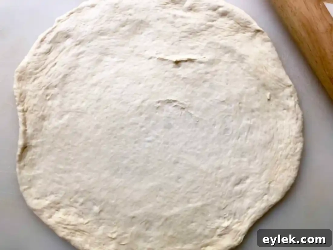Pizza dough topped with creamy white sauce.