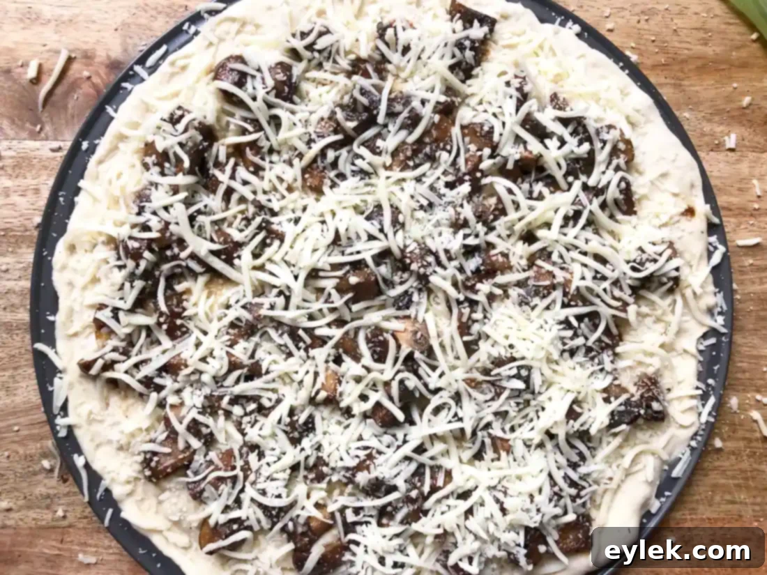 Close-up of a slice of Mushroom Marsala Pizza, showing the rich layers.
