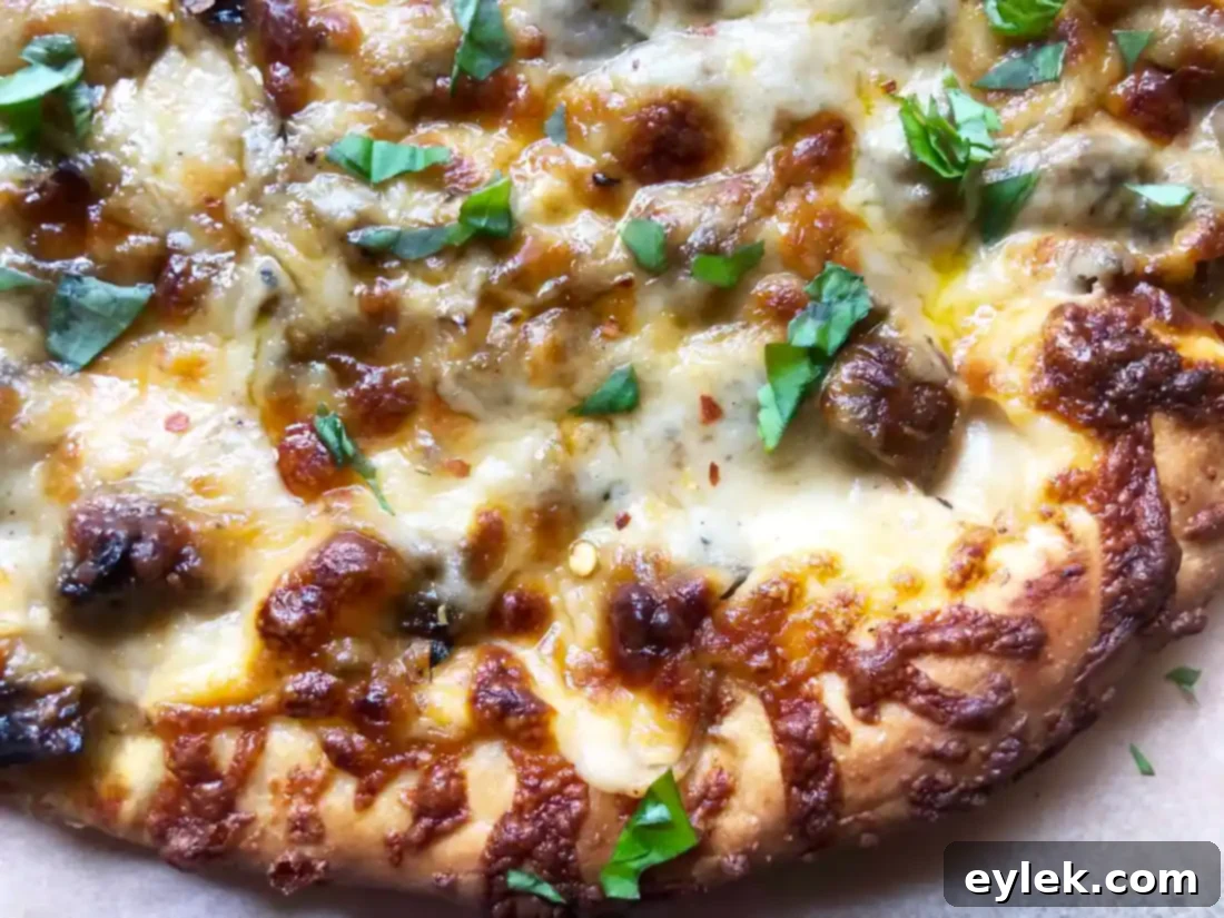 Overhead shot of a full Mushroom Marsala Pizza with balsamic glaze and fresh basil.