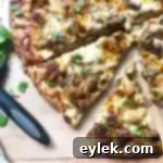 Culinary Mushroom Marsala Pizza Delight 22 A close-up of a slice of Mushroom Marsala Pizza, showcasing the creamy sauce, Marsala mushrooms, and golden crust, garnished with fresh basil.