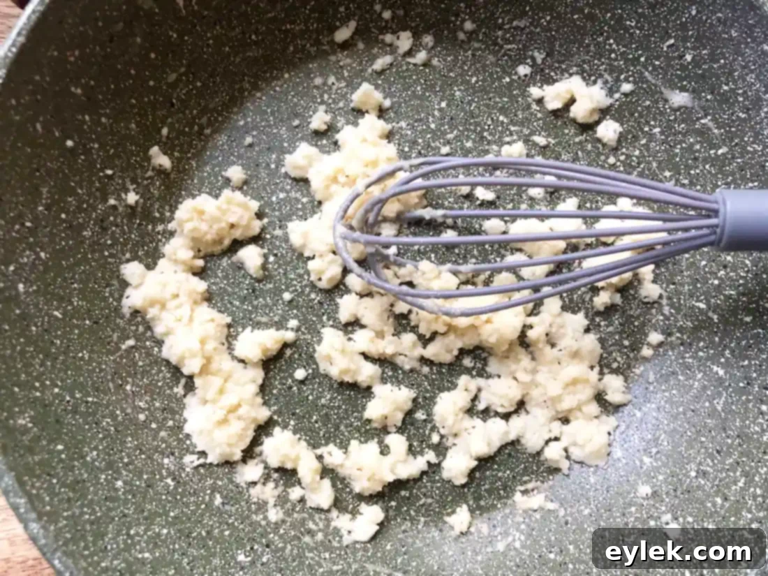 Flour added to melted butter, forming a roux.