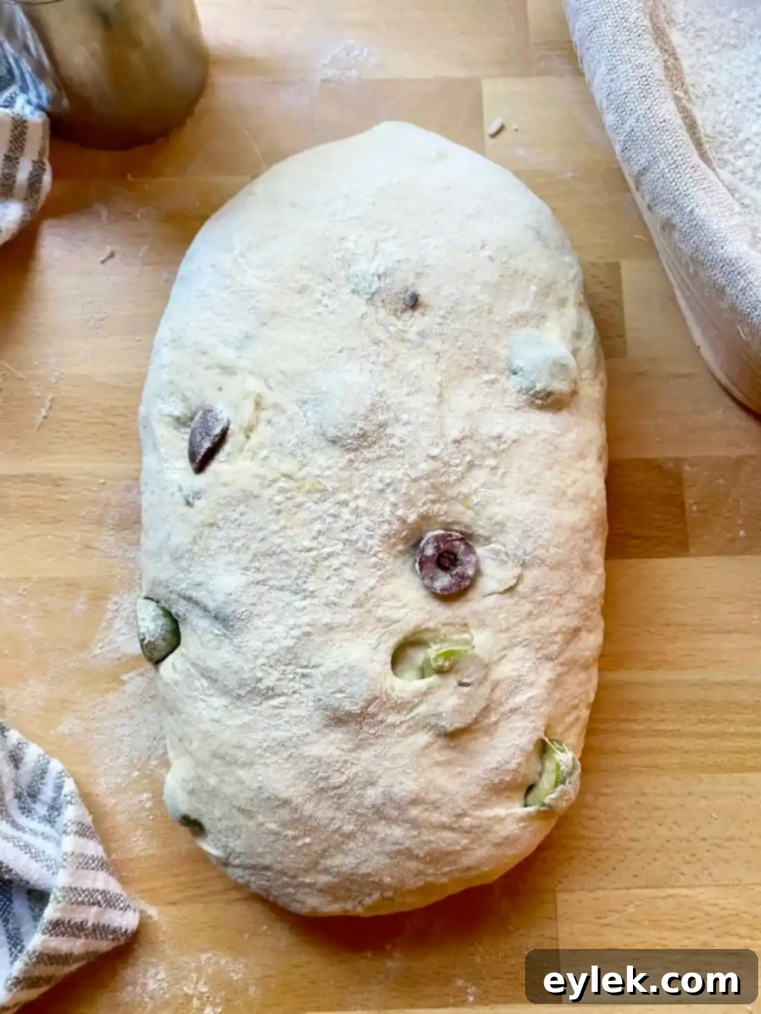 Zesty Olive Thyme Loaf 16 Dough placed seam side up in proofing basket