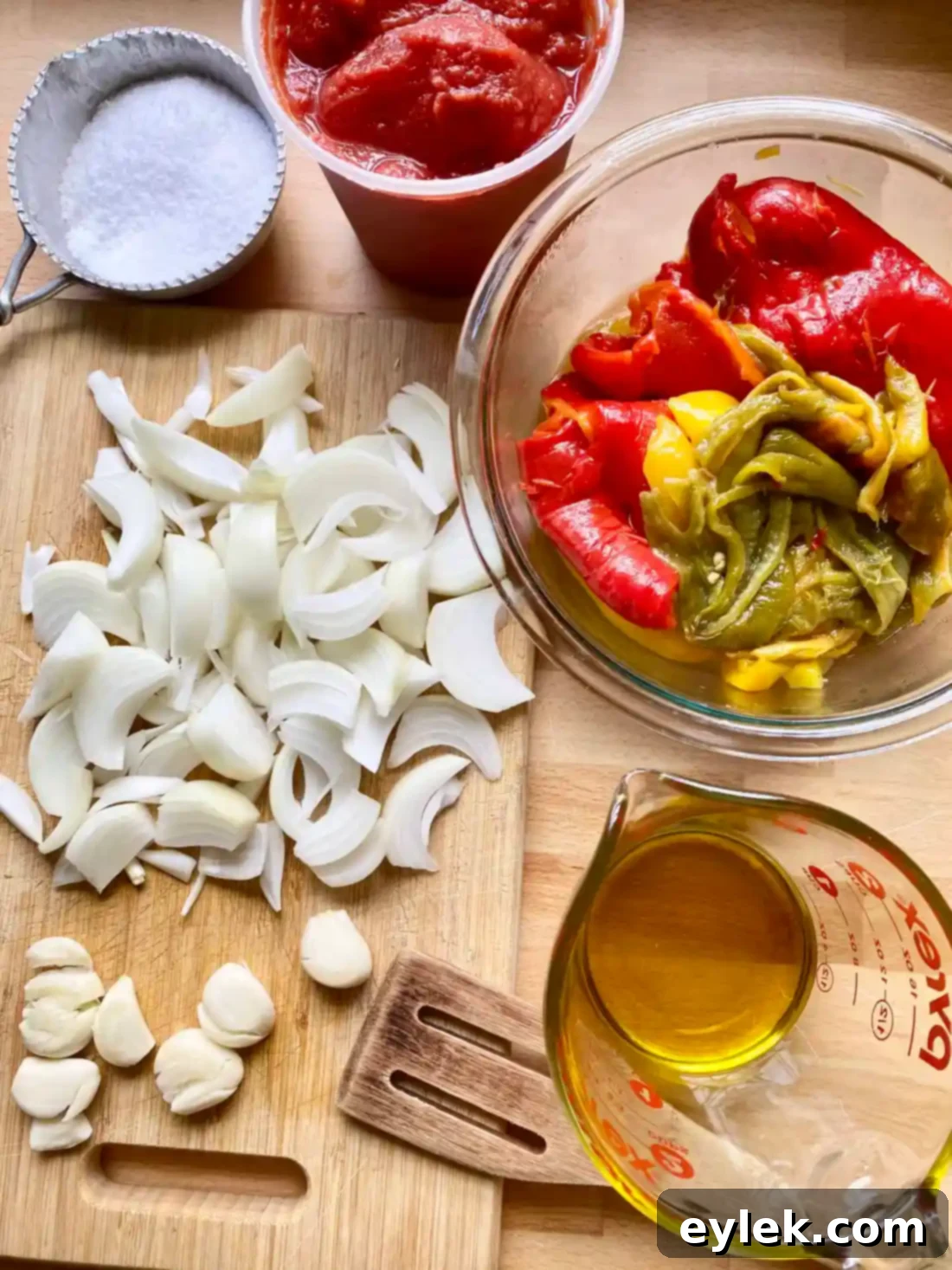 Adding pepper strips to the skillet with onions and garlic