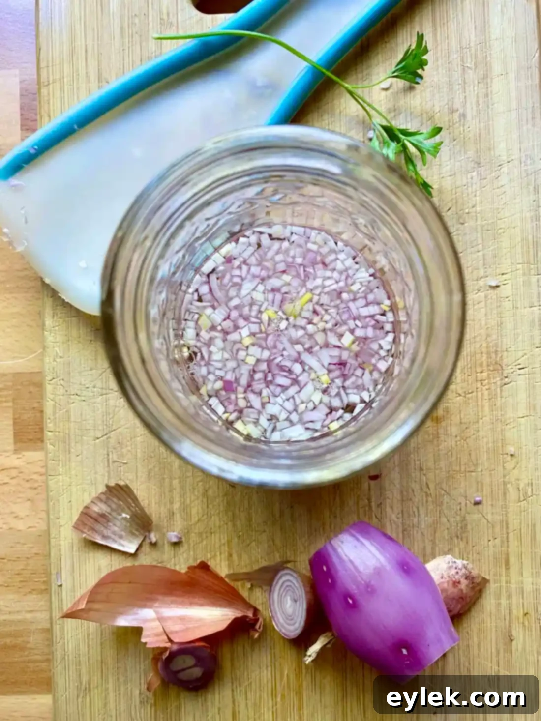 Minced shallots soaking in champagne vinegar in a glass jar.